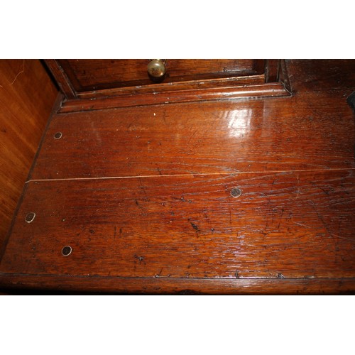 413 - An oak dresser, the upper section fitted two open shelves, two cupboards and two drawers, over three... 