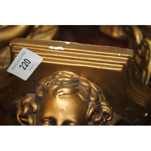 220 - A pair of gilt plaster cherub wall brackets, 11