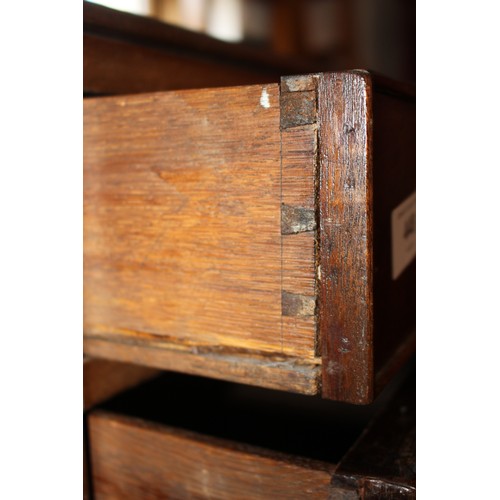 448 - A late Georgian mahogany chest of four long graduated drawers with brass bail handles, on bracket fe... 