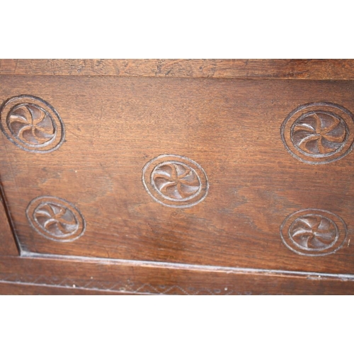 375 - An early 18th century oak chip carved panel front coffer with candlebox, on stile supports, 41