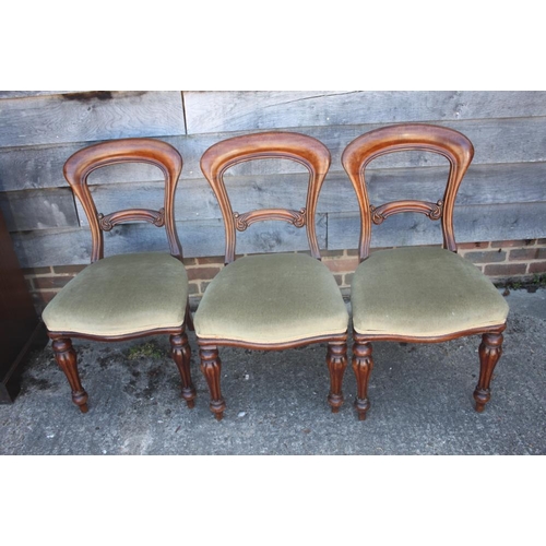 379 - A set of four Victorian carved walnut loop back side chairs, on shaped supports