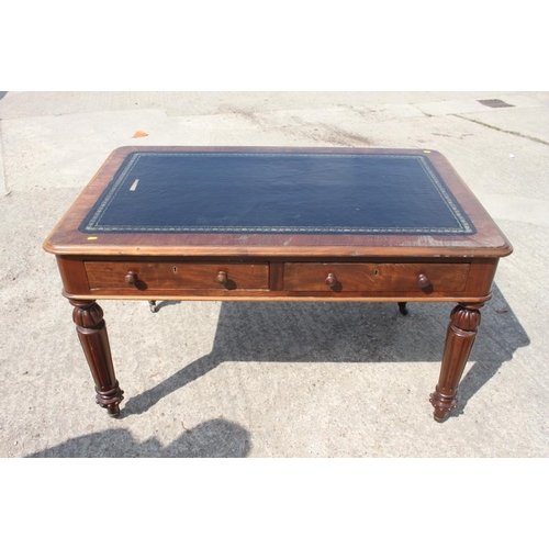 400 - A 19th century walnut library table with tooled lined top, fitted two drawers, on turned and fluted ... 