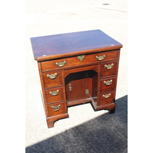 407 - A Georgian mahogany kneehole writing desk with lift-up lid and fitted interior over six drawers and ... 