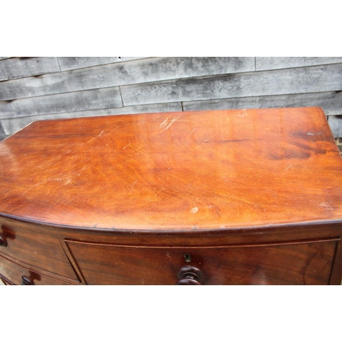 412 - A 19th century mahogany bowfront chest of two short and three long graduated drawers with knob handl... 