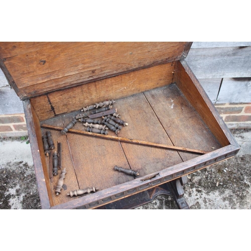 413 - A late 19th century oak fretwork slope top writing desk, on panel end supports, 21 1/2