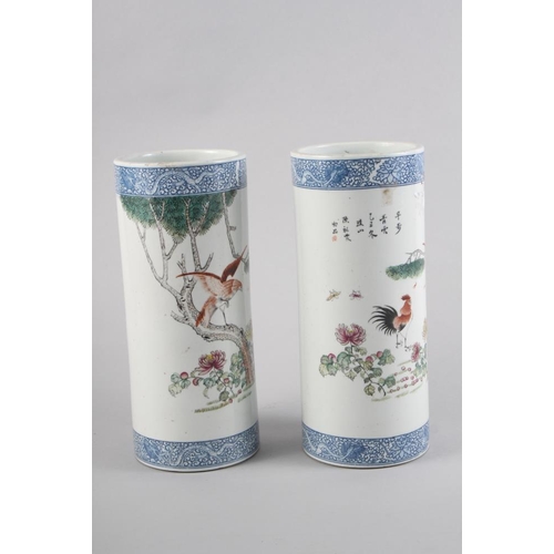 94 - A pair of Chinese cylindrical vases, decorated birds and trees with blue dragon borders, 11