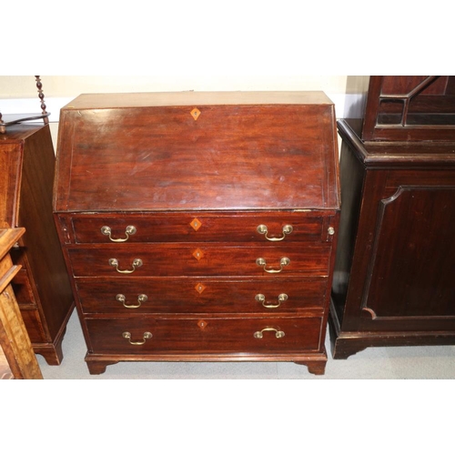 425 - A late Georgian mahogany fall front bureau, the fitted interior over four long graduated drawers wit... 