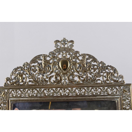 126 - A pierced brass famed easel mirror of restoration design, 19