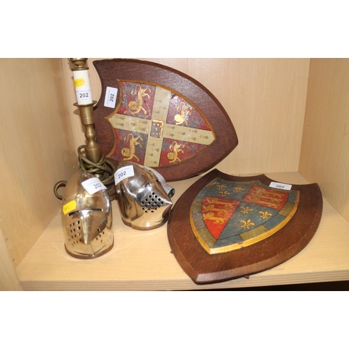 202 - Two painted metal coats of arms on easel stands, 12 1/2