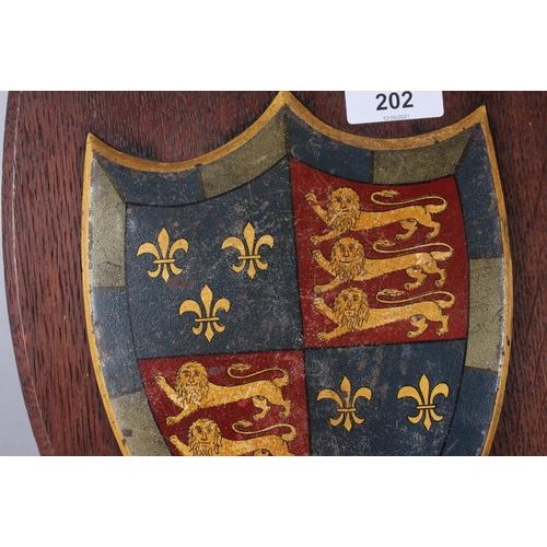 202 - Two painted metal coats of arms on easel stands, 12 1/2