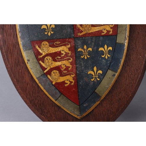 202 - Two painted metal coats of arms on easel stands, 12 1/2