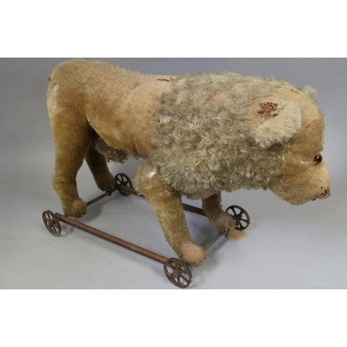 158 - A child's Victorian ride-along straw stuffed lion, 25