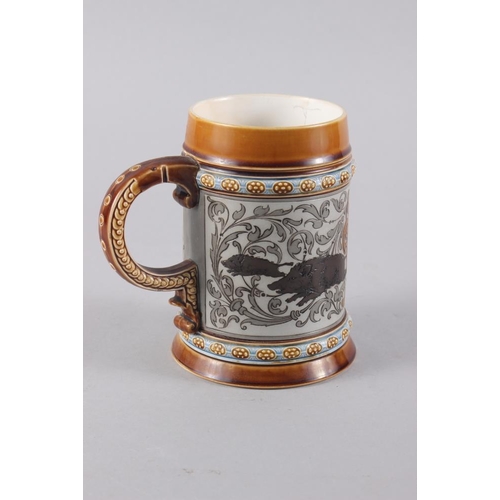 184 - A German Mettlach pottery beer stein, decorated with a huntsman, wild boar and hounds, 5 3/4