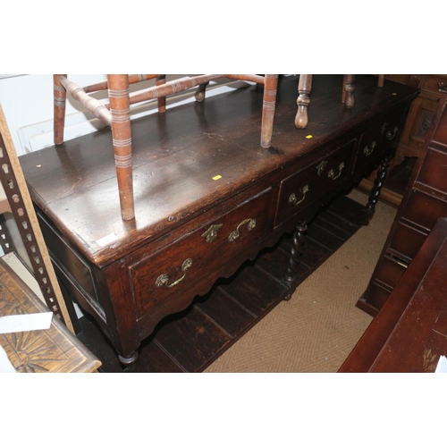 373 - An 18th century oak dresser base, fitted three drawers over pot board, on turned supports, 68