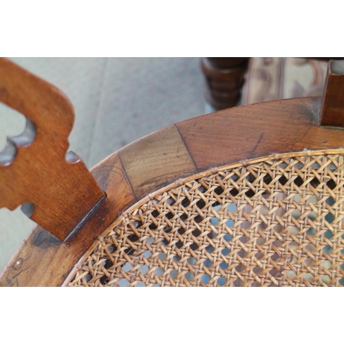 397 - A Victorian mahogany elbow chair with cane panel seat, on turned supports