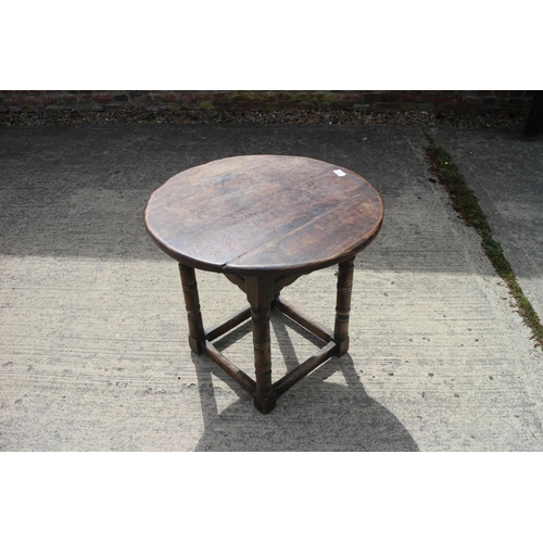 471 - An oak circular top low occasional table, on turned and stretchered supports, 22