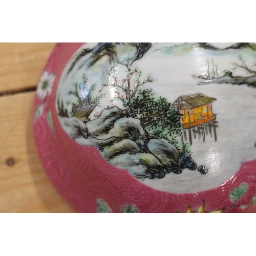 103 - A Chinese porcelain vase-shaped wall pocket with landscape panel on a pink ground, 10 1/2