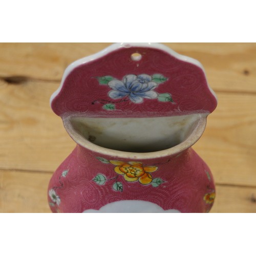 103 - A Chinese porcelain vase-shaped wall pocket with landscape panel on a pink ground, 10 1/2