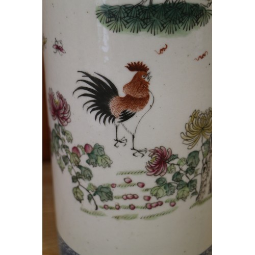 94 - A pair of Chinese cylindrical vases, decorated birds and trees with blue dragon borders, 11