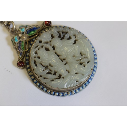 92 - A Chinese pale celadon roundel, decorated figures, in a white metal and enamel pendant frame, three ... 