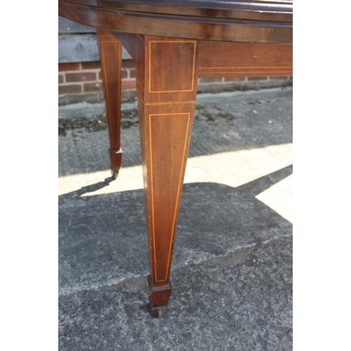 403 - A late 19th century mahogany extending dining table with two extra leaves, on line inlaid square tap... 