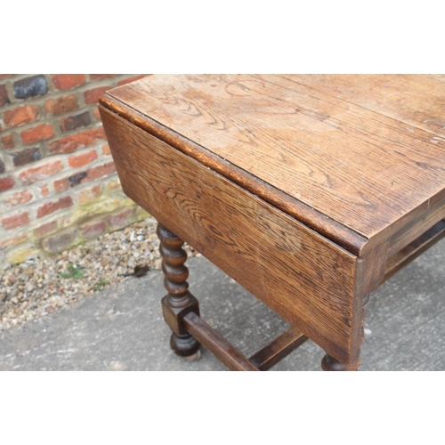 460 - An oak drop leaf table, on barley twist and stretchered supports, 36