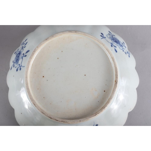 103 - A 19th century blue and white porcelain dish with lobed edge and central willow pattern panel, 10