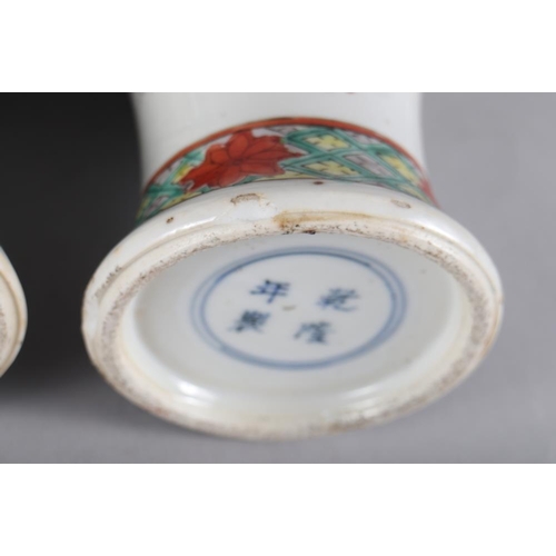 108 - A pair of Chinese porcelain famille verte baluster vases, decorated figures, 10 1/2