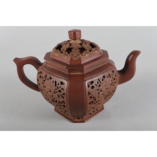 113 - A Chinese Yixing pottery teapot, decorated four pierced panels, impressed mark to base, 5 1/2