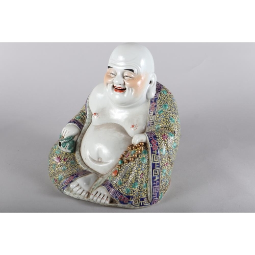 114 - A Chinese porcelain seated Buddha, decorated polychrome enamels, impressed four-character mark to ba... 