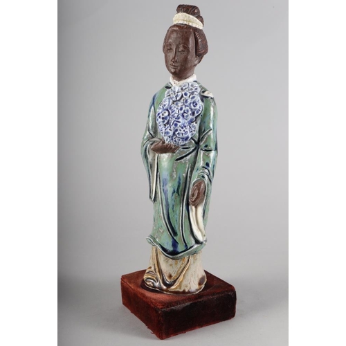 114 - A Chinese porcelain seated Buddha, decorated polychrome enamels, impressed four-character mark to ba... 