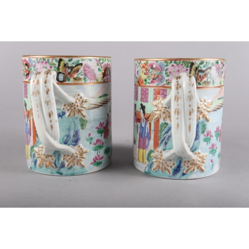 120 - A pair of 19th century Chinese famille verte tankards, decorated initials and entwined strap handles... 