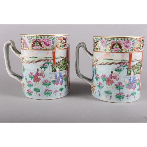 120 - A pair of 19th century Chinese famille verte tankards, decorated initials and entwined strap handles... 