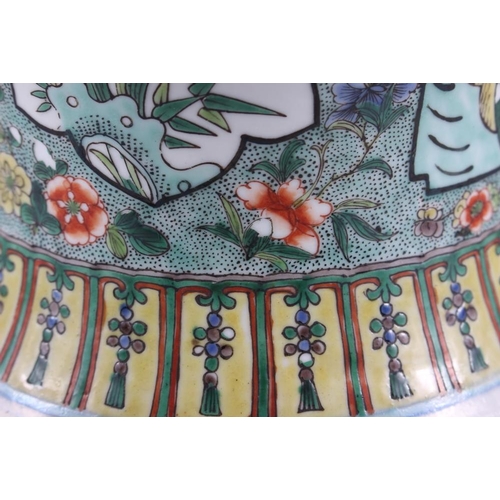 121 - A Chinese porcelain inverted baluster vase and cover, decorated in famille verte enamels, six charac... 