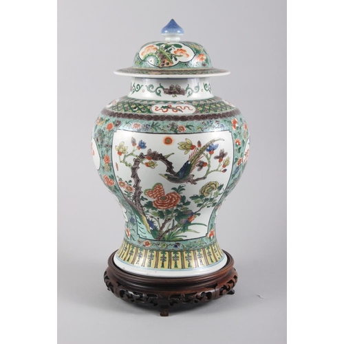 121 - A Chinese porcelain inverted baluster vase and cover, decorated in famille verte enamels, six charac... 