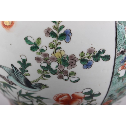 121 - A Chinese porcelain inverted baluster vase and cover, decorated in famille verte enamels, six charac... 