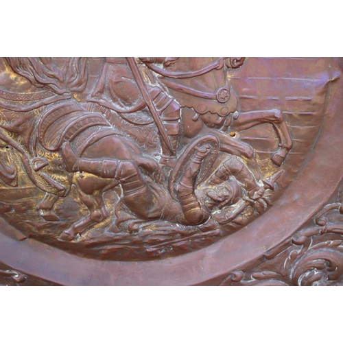 152 - A circular embossed copper plaque, traces of gilding, centre with Battle of Anghiari after Leonardo,... 