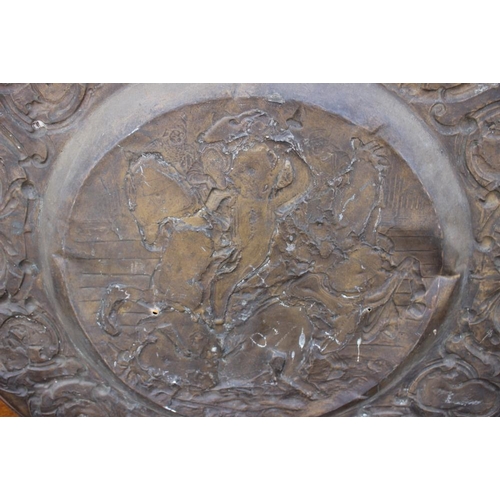 152 - A circular embossed copper plaque, traces of gilding, centre with Battle of Anghiari after Leonardo,... 