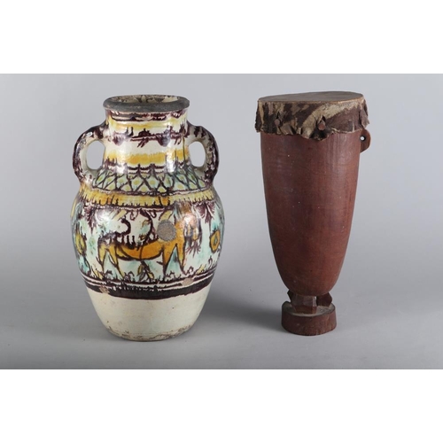 189 - An Iberian slip decorated two-handled vase with floral and animal decoration, 16