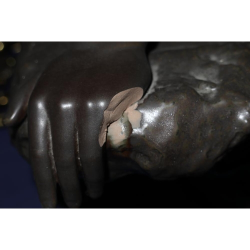 24 - A bronzed Lladro sculpture of a nude woman resting on a rock, base signed 