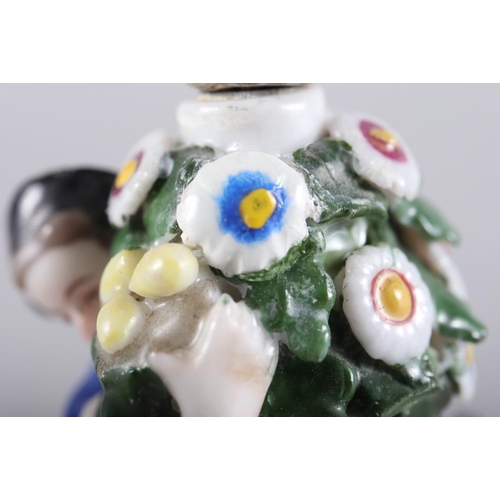 249 - A Continental porcelain scent bottle, in the Chelsea manner, figures round a flowering bush, 4