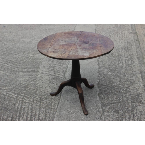 364 - A late 18th century provincial oak circular tilt top occasional table, on cannon barrel turned colum... 