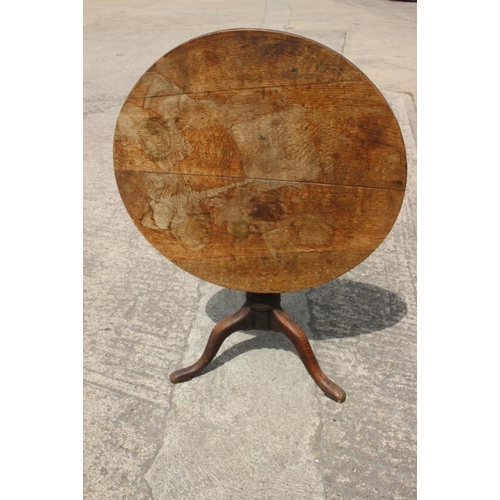 364 - A late 18th century provincial oak circular tilt top occasional table, on cannon barrel turned colum... 