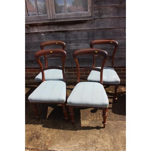 365 - A set of four mid 19th century mahogany balloon back standard dining chairs with stuffed over seats,... 