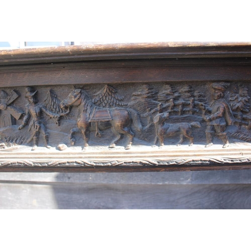 386 - A 19th century carved oak fireplace surround with frieze panel carved figures, horses and windmill, ... 