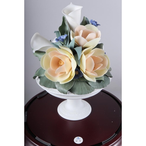 39 - A Lladro porcelain arrangement under a glass dome, 