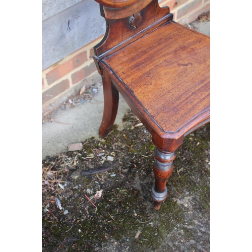 399 - A 19th century mahogany hall chair with Gothic pierced back, on turned supports