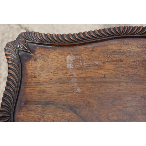 405 - A 19th century carved rosewood shape top occasional table, on cluster column and tripod splay suppor... 