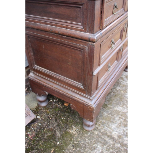 407 - An early 18th century oak two-section chest on stand of four drawers with panelled fronts, 40