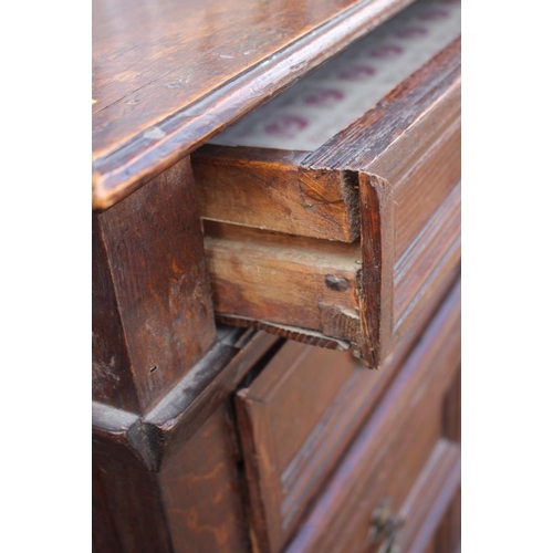 407 - An early 18th century oak two-section chest on stand of four drawers with panelled fronts, 40